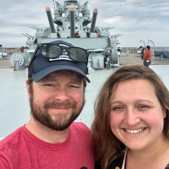 Hannah and Erik smiling together aboard the USS Alabama battleship