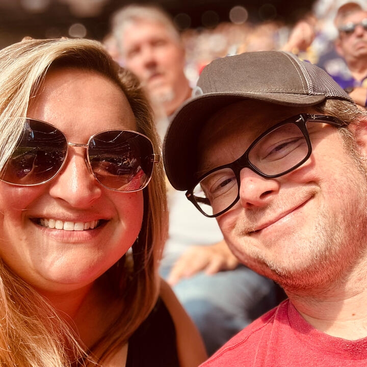 Hannah and Erik smiling together at Badger football game