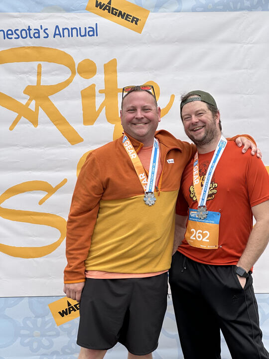 Erik celebrating with a friend after completing a race