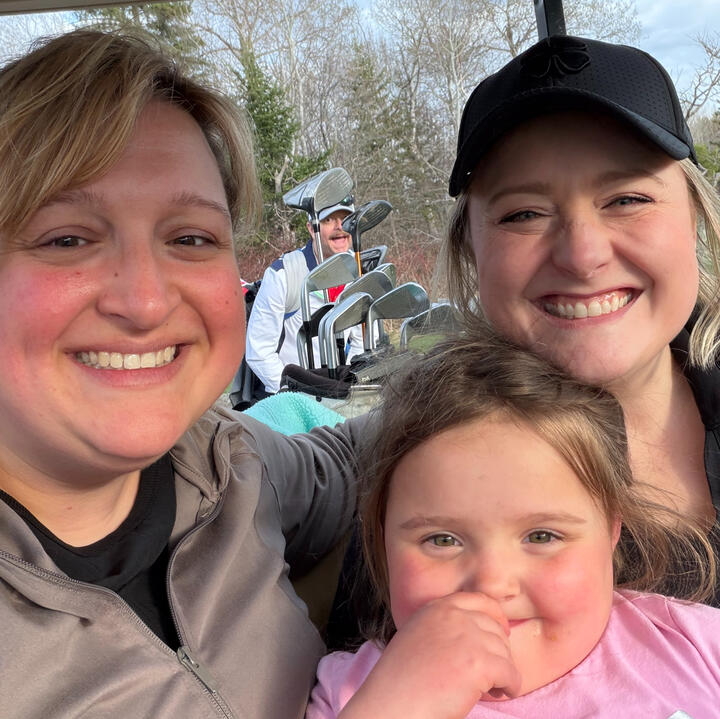 Hannah golfing with sister and niece