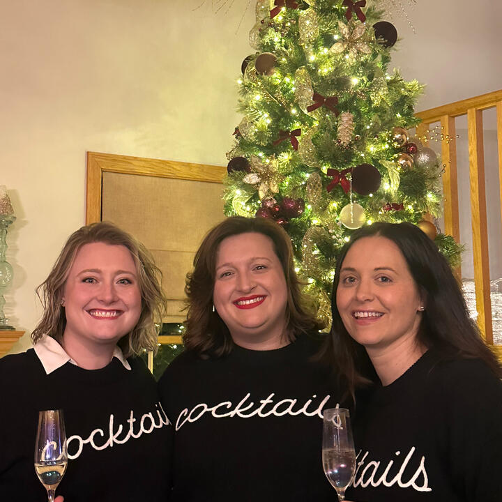 Hannah with friends in front of Christmas tree