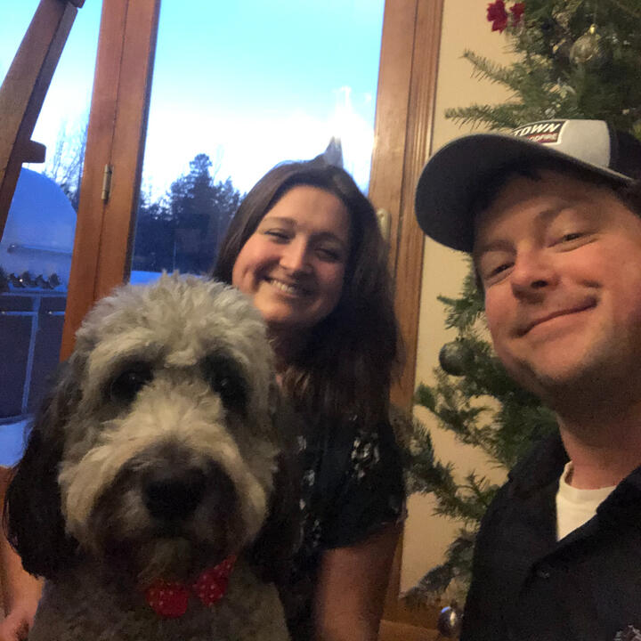 Hannah and Erik posing with Bonnie during the holidays