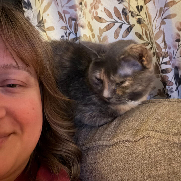 Cleo relaxing beside Hannah during a quiet moment at home