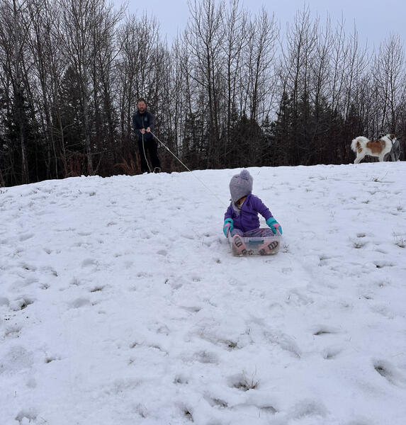 Sledding with Ev in the backyard