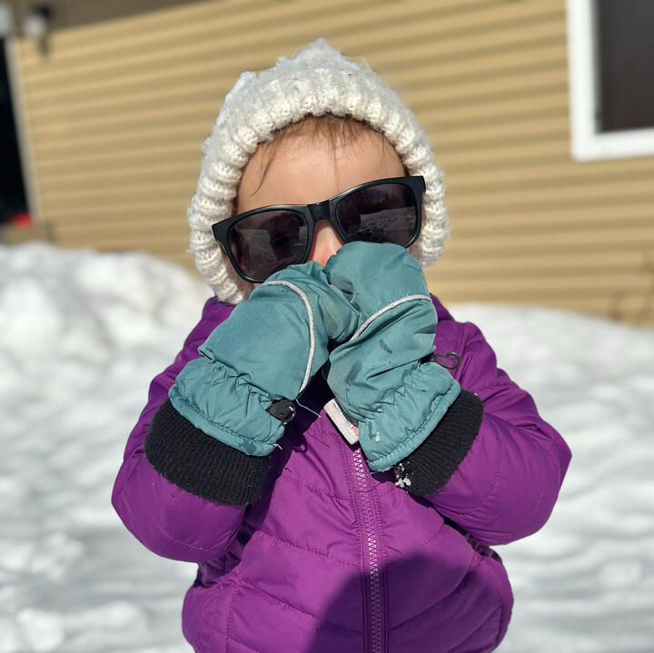 Young niece bundled up and playing outside in winter