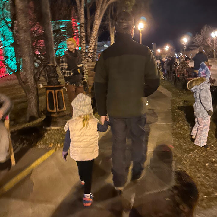 Erik and his young niece walking together hand in hand