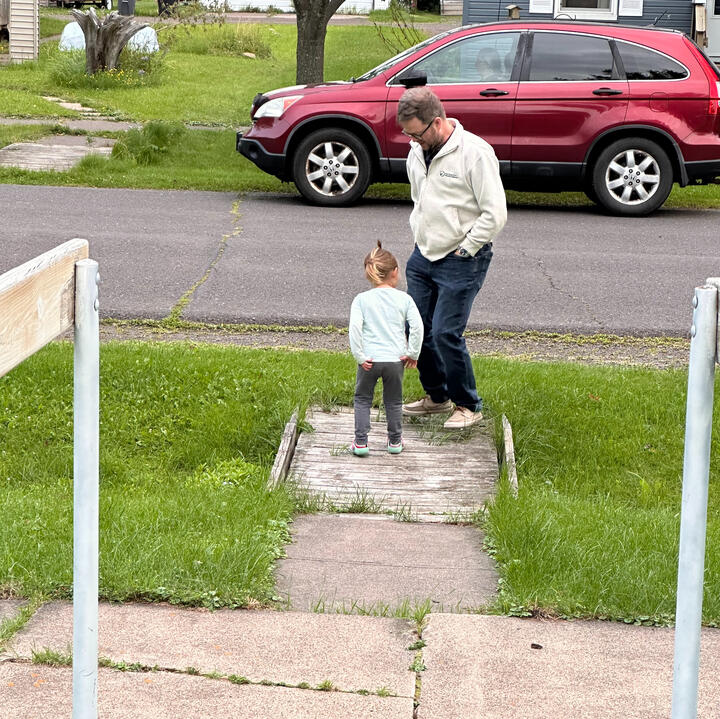 Erik outdoors with young niece waiting for ice cream truck