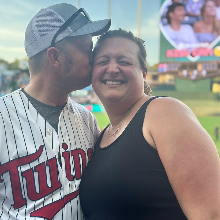 Hannah and Erik smiling together at baseball game