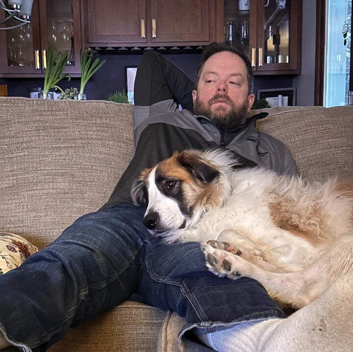 Erik relaxing on the couch with Bernie