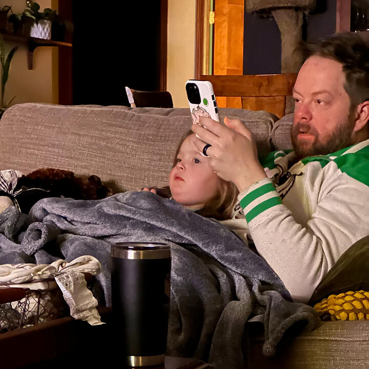 Erik and niece on couch watching TV