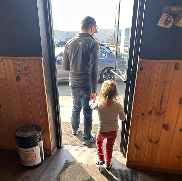 Erik walking hand in hand with a young niece at coffee shop