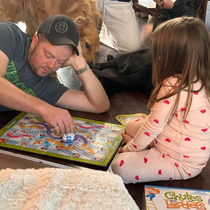 Erik and his young niece playing a game together during a family gathering