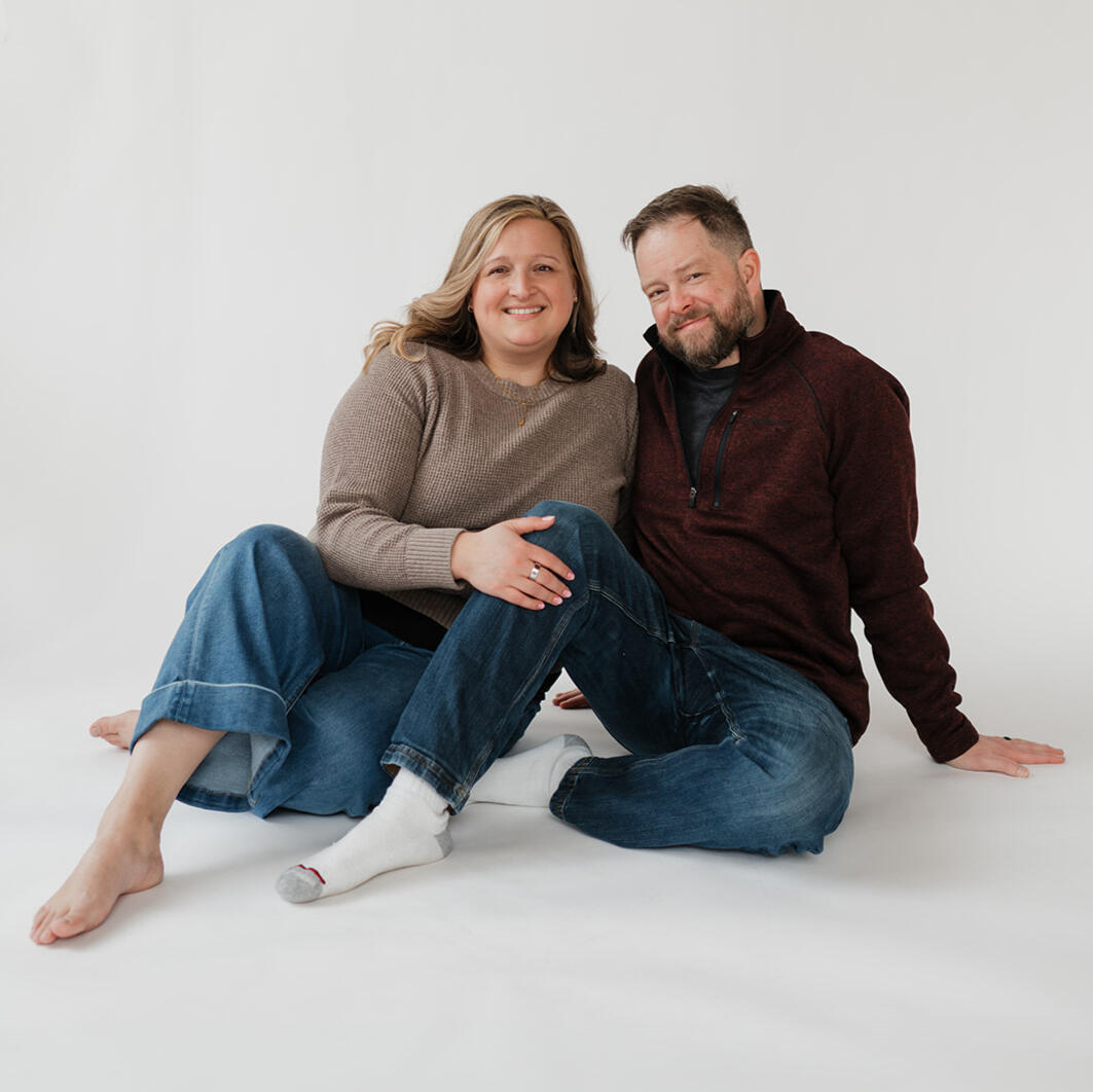 Hannah & Erik Hannah and Erik sitting together and smiling during their adoption profile photo session