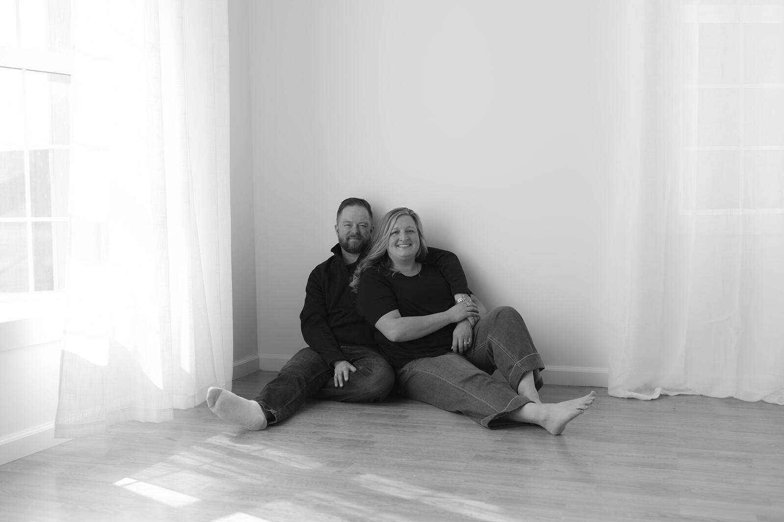 Hannah and Erik sitting together during a quiet moment in their adoption profile session