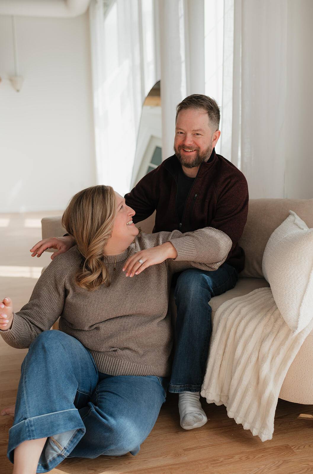 Erik smiling during a relaxed moment with Hannah at their adoption profile photo session